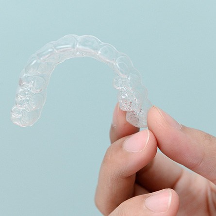 Patient holding clear aligner