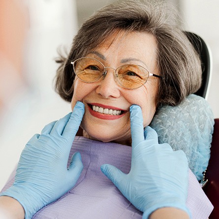 Dentist looking at patient's smile in treatment chair