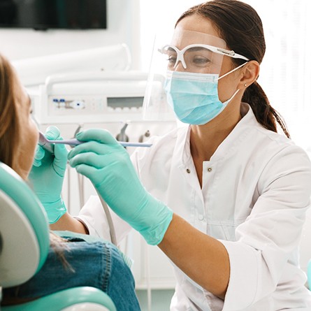 Smiling patient and dentist talking in treatment room
